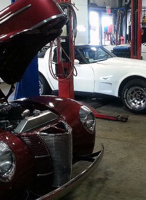 Classic cars inside an automotive repair shop